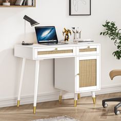 a white desk with a laptop on it