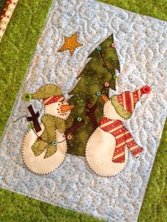 a quilted christmas tree with two snowmen