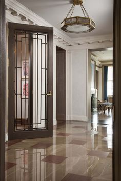 an open door leading to another room with a chandelier