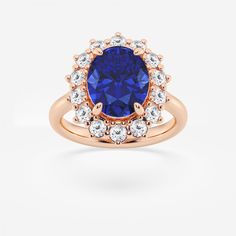 a tan gold ring with a blue sapphire surrounded by white diamonds