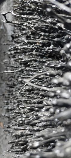 close up view of chain link fence with water droplets on the top and bottom part