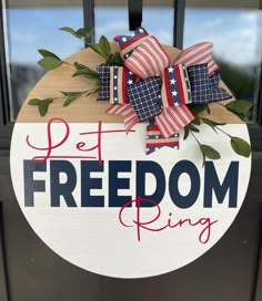 a sign that says pet freedom ring hanging on a door with some ribbons attached to it