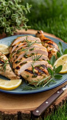 grilled chicken with herbs and lemons on a blue plate