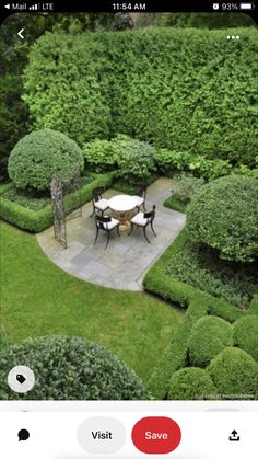 an aerial view of a garden with tables and chairs in the center, surrounded by hedges