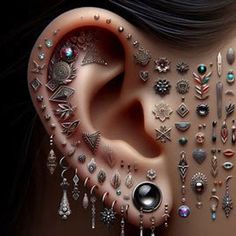 a woman's ear with lots of piercings on it