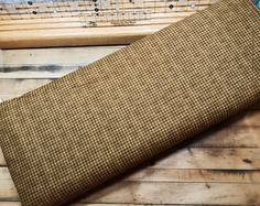 a close up of a piece of cloth on a wooden floor with musical instruments in the background