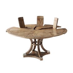 a round wooden table with chairs around it