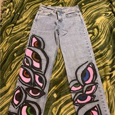 a pair of jeans with colorful designs on them