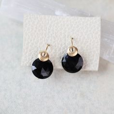 These earrings feature round black spinel gemstones set on gold hooks, with a single bubble accent adding a touch of modern elegance. Round Black Spinel 18k gold Vermeil 3/4' Handmade by Austin Titus Studio in Richmond, VA Elegant Black Everyday Earrings, Black Drop Earrings With French Hook, Elegant Everyday Round Crystal Earrings, Yellow Gold Onyx Round Earrings, Black 14k Gold Earrings For Evening, Elegant Everyday Jewelry With Black Spinel, Elegant Black French Hook Earrings, Black Faceted Earrings As A Gift, Faceted Black Earrings Gift