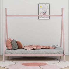 a pink metal bed frame with pillows and blankets on it in front of a white wall