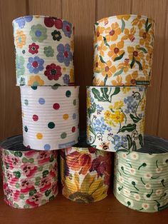 several rolls of toilet paper are stacked on top of each other, with colorful flowers all over them