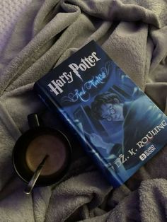 a harry potter book laying on top of a bed