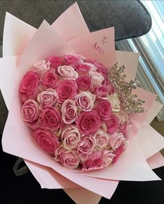 a bouquet of pink and white roses in paper