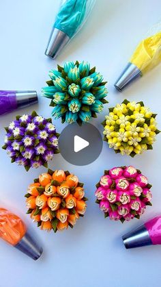 an arrangement of different colored flowers arranged in a circle