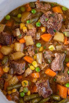 a bowl filled with meat and vegetables on top of a table