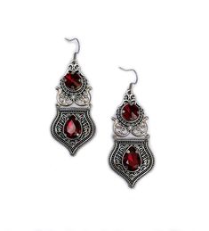 These elegantly ornate earrings are made with antique silver tone filigrees and pendants, featuring romantic scrolls and beautifully balanced details. This mesmerizing design is accented with dazzling dark ruby red glass crystals/jewels. Earrings measure 3" tall, including the stainless steel earring hooks, and are slightly over an inch wide.Matching necklace is listed in our store in a variety of colors. If you don't see items with a color you want, feel free to ask about availability. Ornate Red Filigree Earrings, Red Metal Filigree Jewelry, Goth Victorian Wedding, Ornate Earrings, Gothic Antique, Goth Victorian, Garnet Crystal, Victorian Wedding, Choker Pendant