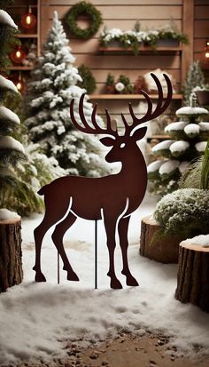 a metal deer standing in the snow next to some trees and christmas decorations on display