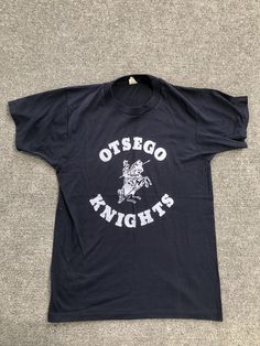 Vintage 80s OTSEGO KNIGHTS black and white tee  Screen stars  Reads M  50/50  Single stitch Excellent vintage condition, seems Deadstock but no tags and I washed it  Measurements taken laying flat  Pit to pit 17  Length 25  #school #sports #1980s #college #camp Retro Black T-shirt For School, Retro Black T-shirt For College, Black And White Tees, Vintage School, School Mascot, School Sports, White Tee, Toledo, 50 50