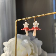 Our lovely mushroom umbrella earrings are made with resin mushroom and 14k gold plated earring hook which are good for delicate ears. Size: the length is about 1.5" Cute Dangle Earrings With Mushroom Design, Cute Mushroom Design Dangle Earrings, Whimsical White Mushroom Design Earrings, White Dangle Earrings With Mushroom Design, White Earrings With Mushroom Design As Gift, White Mushroom Design Earrings For Gift, White Mushroom Design Earrings As Gift, Cute White Earrings With Mushroom Design, White Mushroom Design Drop Earrings