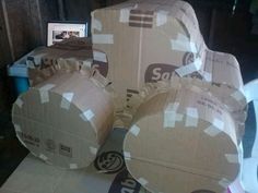 several cardboard boxes are stacked on top of each other in front of a laptop computer