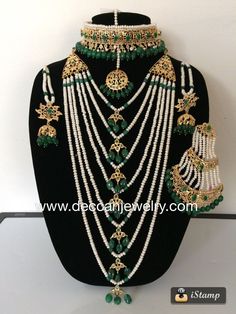 an elaborate necklace and earring set with pearls, emerald green beads and gold accents