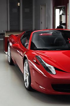 a red sports car parked in a garage