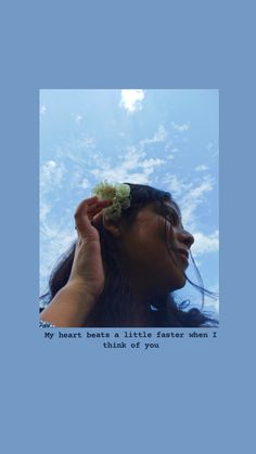 a woman with a flower in her hair is looking up at the sky and smiling