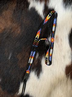 "1/4\" wide All bead work is beaded with 10lb extreme braided nylon line. All hat bands are finished at 23\" with glued than sewed down leather ends and an adjustable leather tie." Handmade Adjustable Western Beaded Necklace, Adjustable Beaded Necklaces, Southwestern Adjustable Multicolor Hat Bands, Adjustable Southwestern Multicolor Hat Bands, Adjustable Multicolor Southwestern Hat Bands, Southwestern Adjustable Black Hat Bands, Traditional Adjustable Multicolor Hat Bands, Adjustable Multicolor Western Jewelry, Traditional Multicolor Adjustable Hat Bands