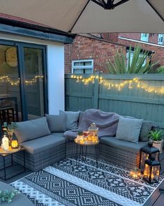 an outdoor patio with lights and furniture