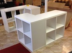 a white book shelf sitting on top of a red rug