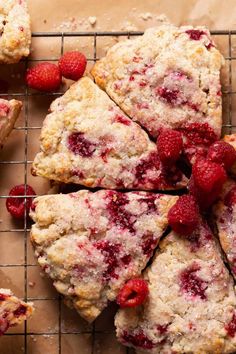 raspberry scones on a cooling rack with fresh raspberries around them