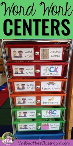 a stack of colorful bins with words and pictures on them in front of a classroom desk