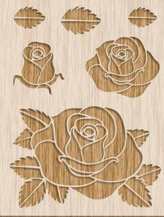 a wooden stamp with roses and leaves on the bottom, and two smaller ones in the middle