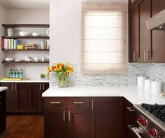 a kitchen with brown cabinets and white counter tops