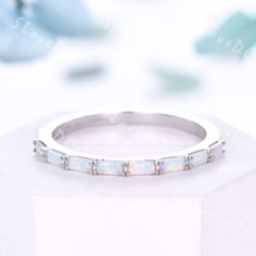 a white gold wedding band with opal stones