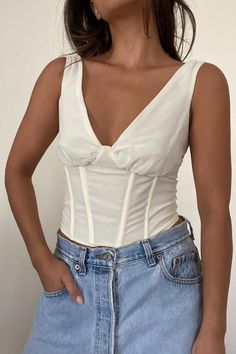 | V-Neck Corset Smocked Back Top | Self: 100% Polyester | Lining: 100% Cotton   * MODEL IS 5'7″ AND IS WEARING A SMALL Ruched V-neck Smocked Top, White V-neck Tops With Smocked Back, White V-neck Top With Smocked Back, Fitted V-neck Smocked Top With Ruched Detail, Fitted Cotton V-neck Smocked Top, White V-neck Smocked Top, Solid V-neck Top With Smocked Bodice, V-neck Top With Smocked Bodice, Cotton V-neck Top With Smocked Bodice