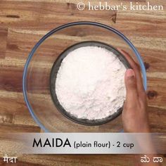 a person is mixing flour in a bowl on a wooden table with the words, mada plain flour - 2 cup