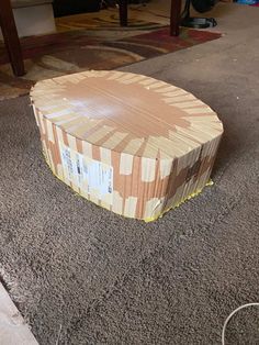 a cardboard box sitting on top of a carpeted floor