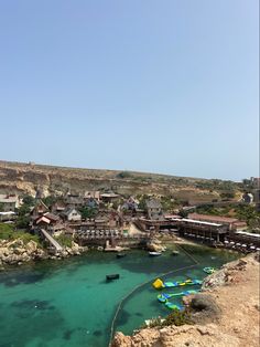 the water is crystal blue and clear with boats in it