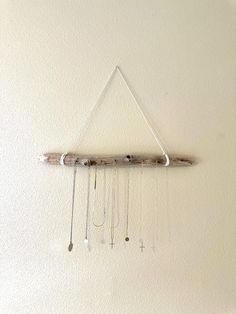 a wind chime hanging from the side of a wall