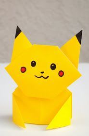 a yellow origami cat with red eyes