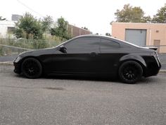 a black sports car parked in a parking lot