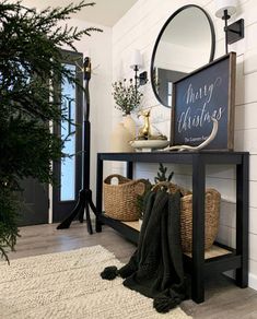 the entryway is decorated with black and white accents, such as a sign that says merry christmas