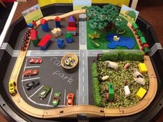 a play table with cars and trucks on it