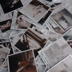 many polaroid pictures are scattered on the bed