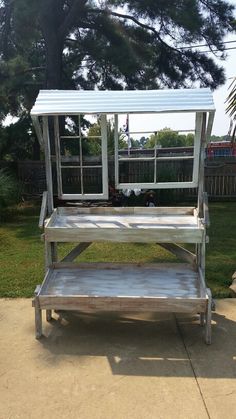 a metal bench sitting on top of a sidewalk