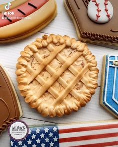 an american flag cookie next to some cookies and other desserts on a table with the words happy labor's day written across it