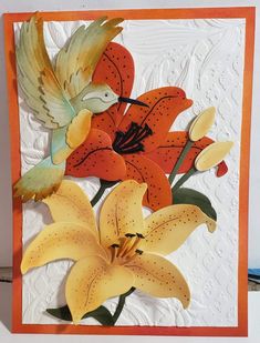 a close up of a greeting card with flowers and a bird on the top of it