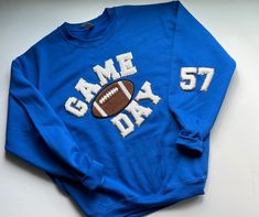 Sport your favorite Team Colors and customize with your favorite player's number. This Sweatshirt is so perfect for game day. The Chenille Letters have a glitter backing and sparkle in the light.  Oh so preppy and stylish! Unisex Sweatshirt is not fitted, loose fitting for extra comfort.  *Sweatshirt shown is Gildan Brand Unisex *Interested in a different sweatshirt color? let us know when you check out. Arbonne Logo, Varsity Patches, Crochet Bun Hat, Fur Pom Pom Beanie, Hoodie Diy, Hoodie Ideas, Letter Sweatshirt, Vintage Trucker Hats