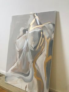 an abstract painting sitting on top of a wooden floor next to a white and gray wall